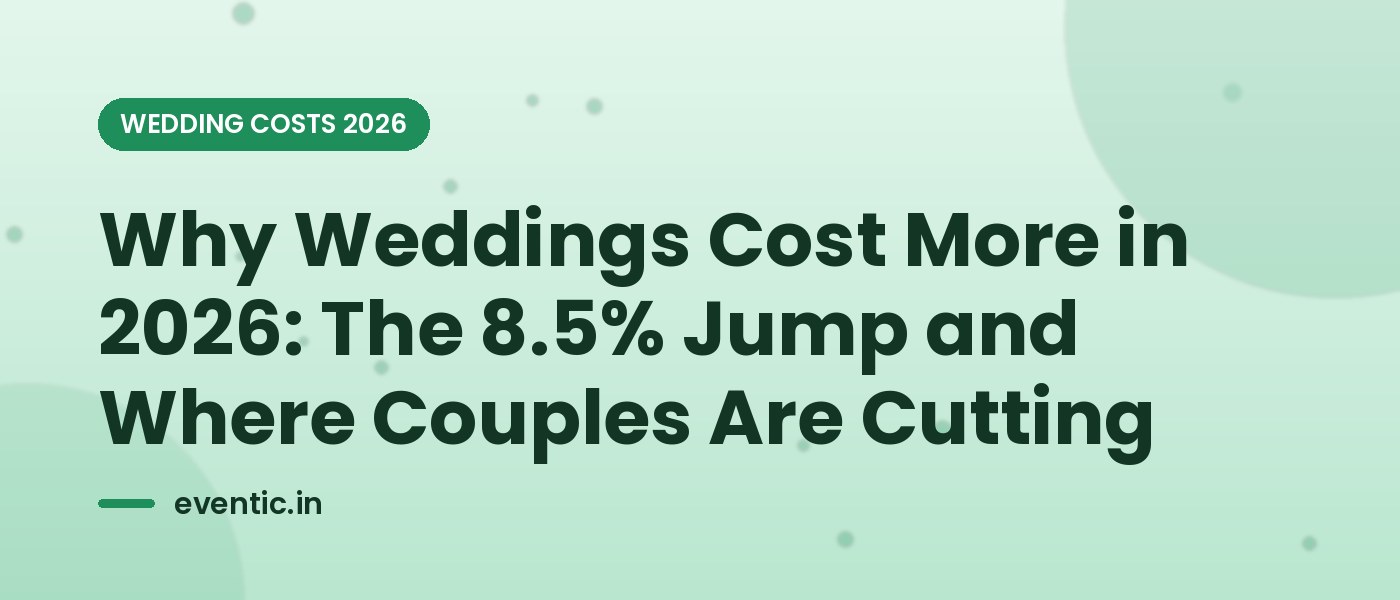 A simple white grocery-store wedding cake on a stand beside a budget notebook and calculator