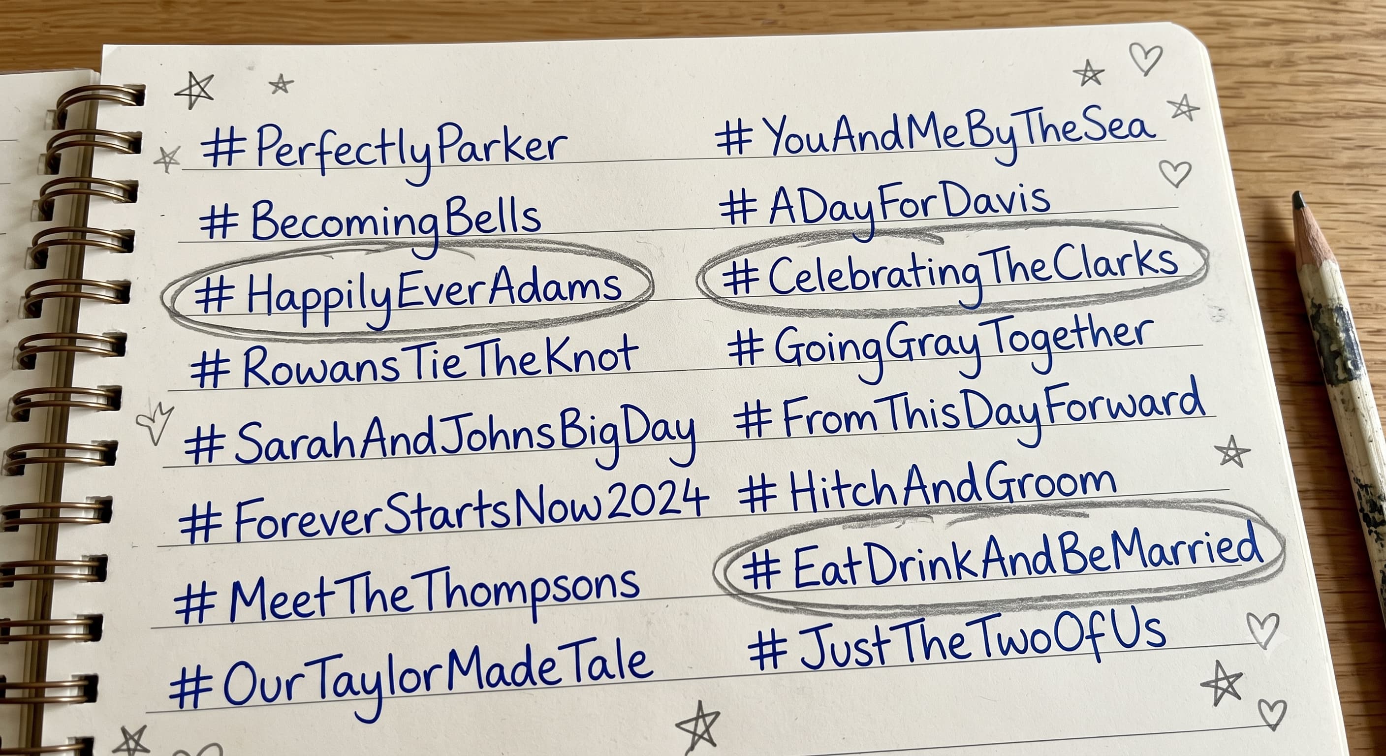 A notebook page listing wedding hashtag options in handwriting, with three of them circled in pencil.